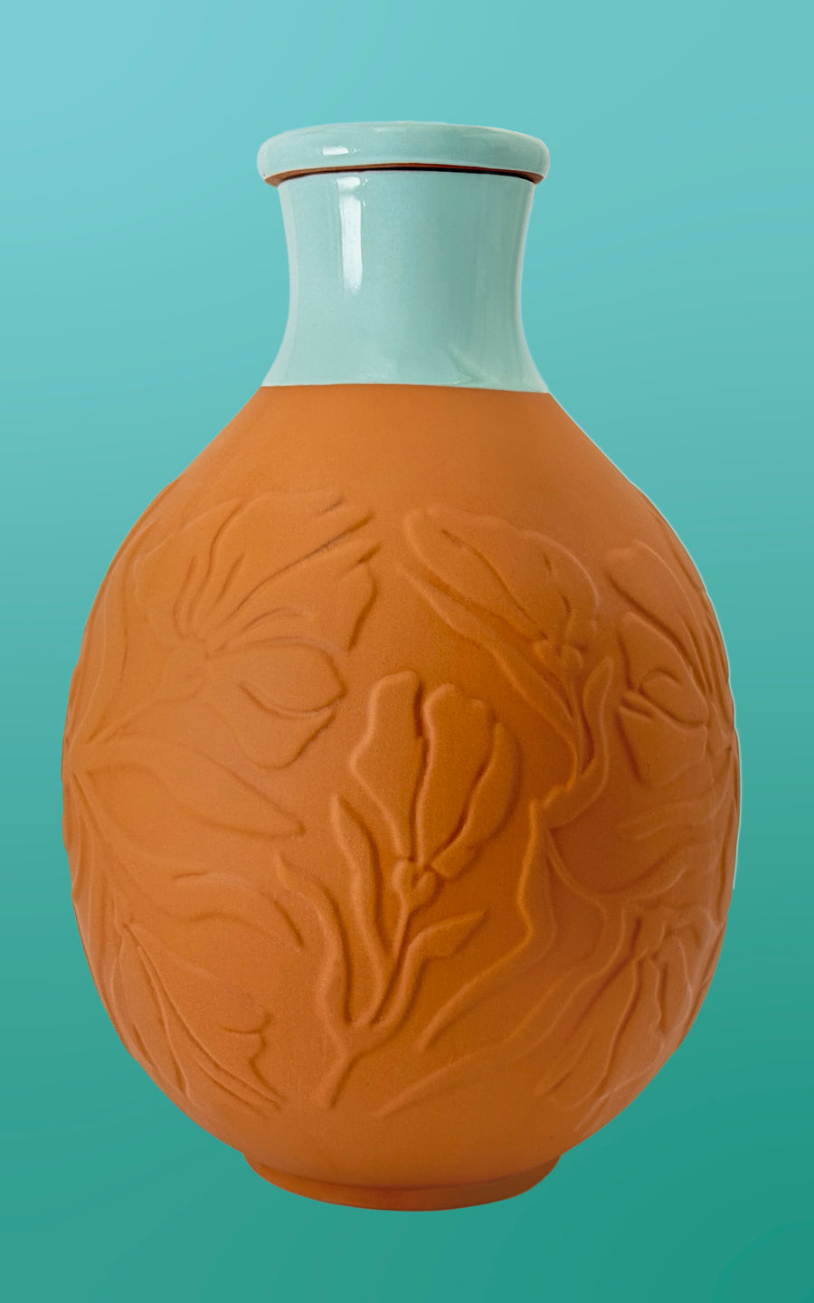 BabaBerry AcquaOlla terracotta self-watering olla pot with embossed botanical leaf pattern and blue glazed ceramic neck, product photo on teal background — unglazed clay olla for slow deep watering of indoor plants
